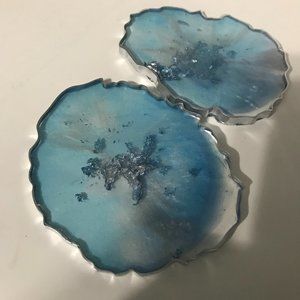 Abstract set of 2 resin coasters, blue and silver.